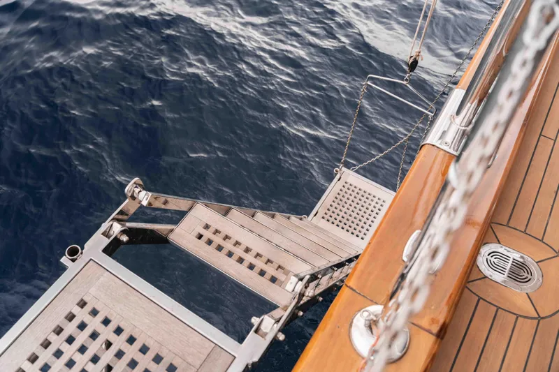 Le Pietre Yacht Photos Pics Custom 2009 sailing yacht with teak deck and stainless steel boarding ladder over ocean.