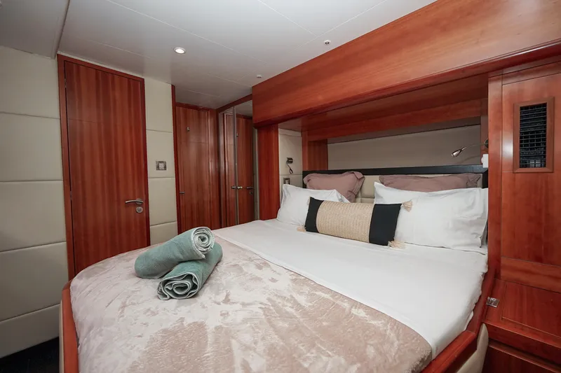  Yacht Photos Pics Luxurious bedroom interior of 2010 Fountaine Pajot Queensland 55 yacht with elegant wood finishes.