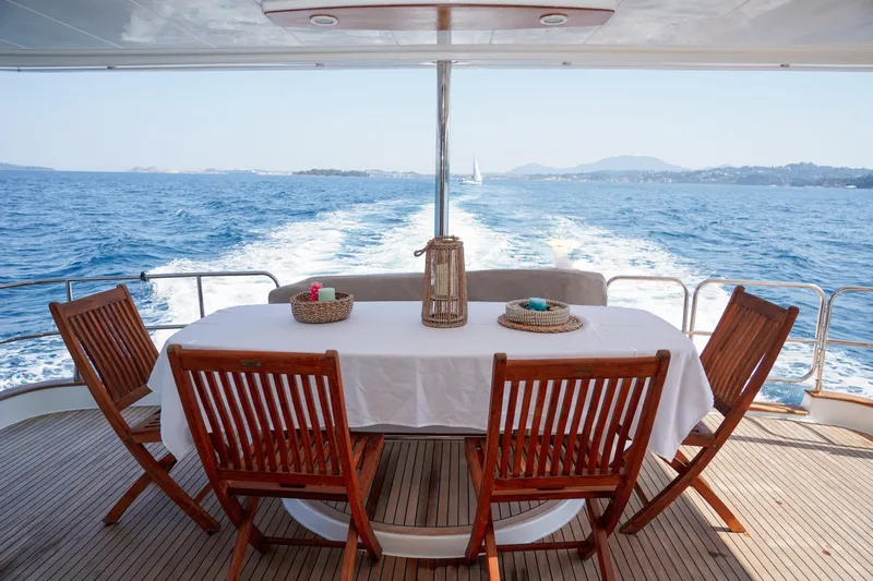  Yacht Photos Pics Luxury dining area on 2010 Fountaine Pajot Queensland 55 yacht, overlooking ocean waves.