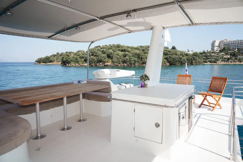  Yacht Photos Pics Luxurious 2010 Fountaine Pajot Queensland 55 yacht deck with seating, table, and ocean view.