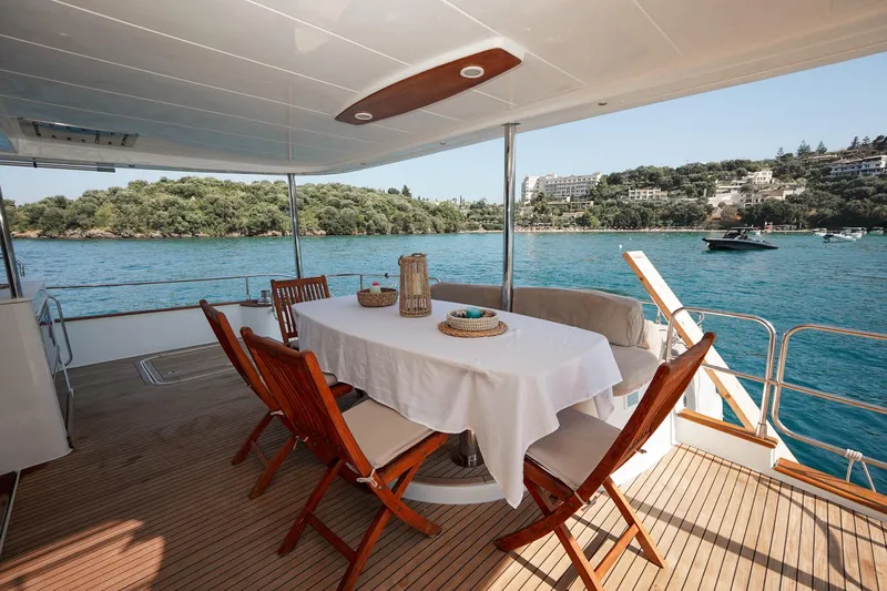  Yacht Photos Pics Luxury dining area on 2010 Fountaine Pajot Queensland 55 yacht, overlooking serene waters.