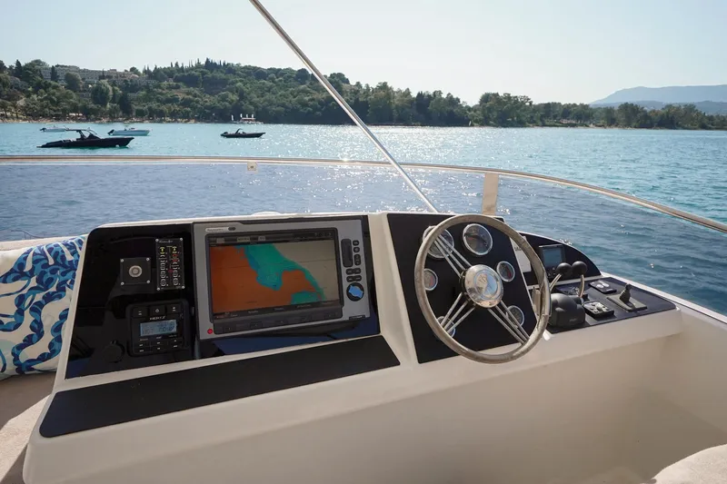  Yacht Photos Pics Helm of 2010 Fountaine Pajot Queensland 55 yacht with navigation display, steering wheel, and controls.