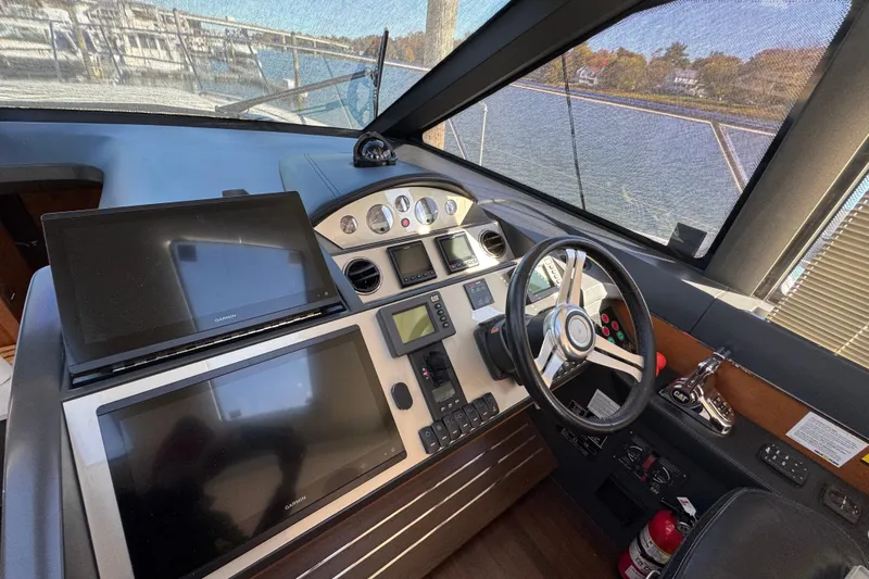 Yacht Photos Pics Cockpit of 2015 Viking Princess V52 yacht with navigation screens and steering wheel.
