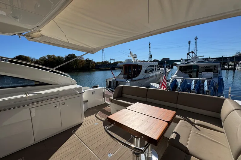  Yacht Photos Pics Luxury 2015 Viking Princess V52 yacht interior with seating and table, docked at marina.
