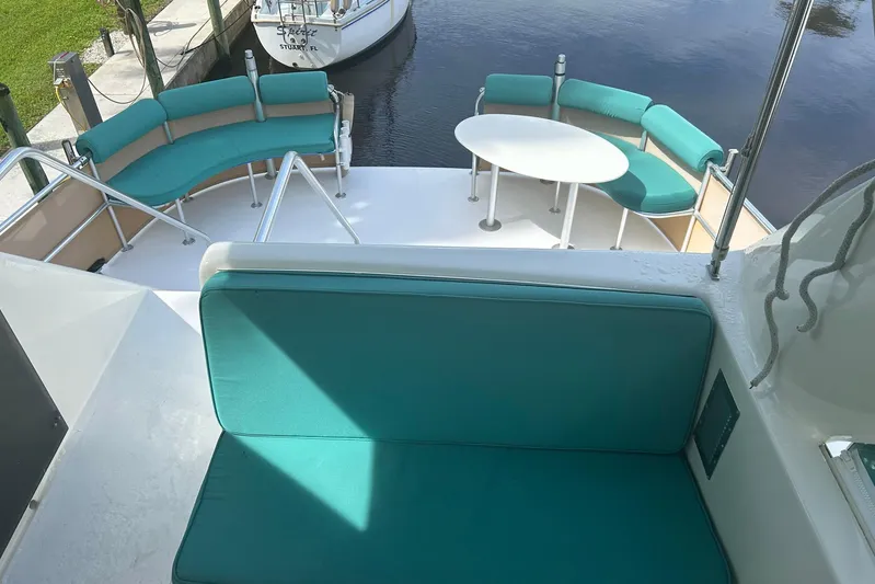 Jonny Wasabi Yacht Photos Pics Luxurious 2002 Custom 64 Stuart Catamarans with teal seating and white table on deck.