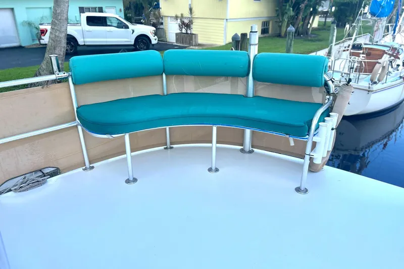 Jonny Wasabi Yacht Photos Pics Turquoise seating on 2002 Custom 64 Stuart Catamarans, docked near a white truck and yellow house.