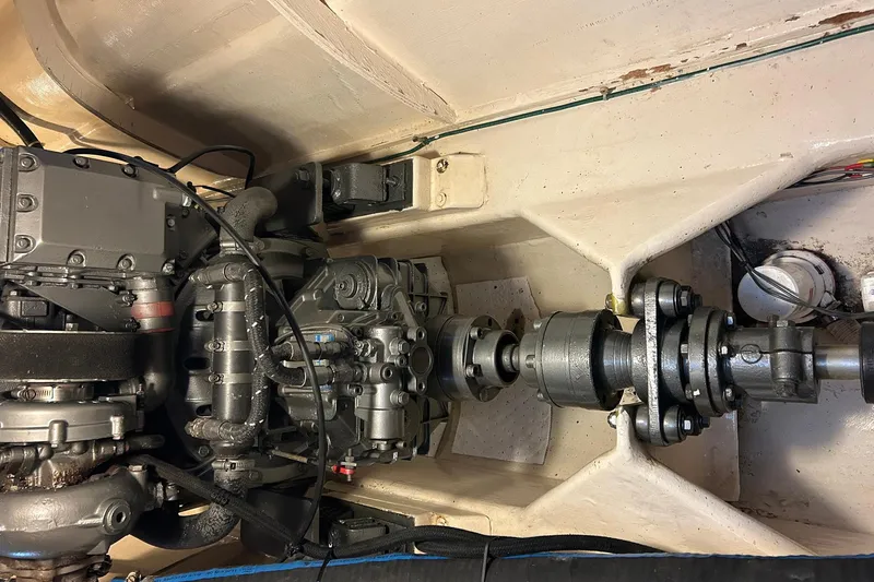 Jonny Wasabi Yacht Photos Pics Engine compartment of a 2002 Custom 64 Stuart Catamarans, showcasing mechanical components and drive shaft.