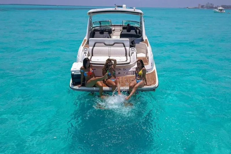  Yacht Photos Pics 2017 Sea Ray SLX 350 with three people enjoying the turquoise ocean waters.