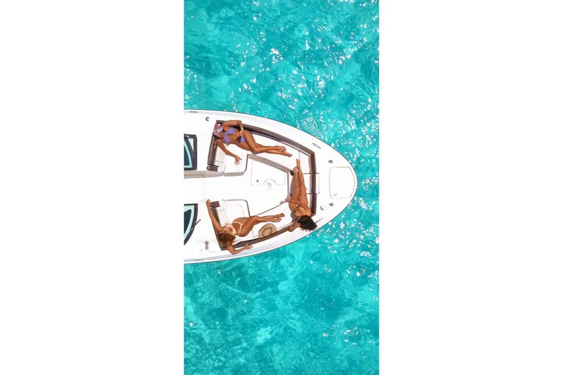  Yacht Photos Pics Aerial view of 2017 Sea Ray SLX 350 with people relaxing on deck in turquoise water.