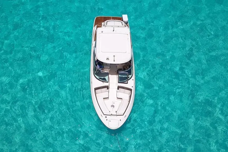  Yacht Photos Pics Aerial view of 2017 Sea Ray SLX 350 boat on clear turquoise water.