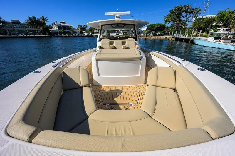 Leap Year Yacht Photos Pics 2018 Pursuit S 408 Sport boat with spacious seating on a sunny waterfront.