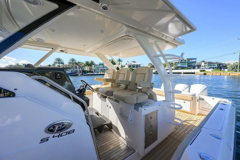Leap Year Yacht Photos Pics 2018 Pursuit S 408 Sport boat interior with luxurious seating and waterfront view.