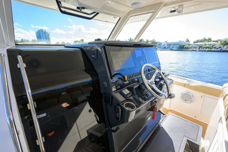 Leap Year Yacht Photos Pics 2018 Pursuit S 408 Sport boat helm with modern controls and waterfront view.
