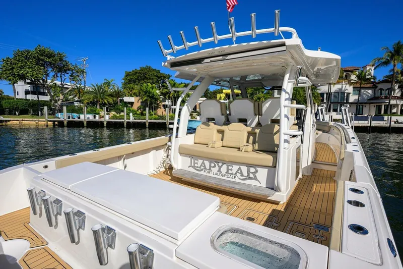 Leap Year Yacht Photos Pics 2018 Pursuit S 408 Sport boat docked, featuring spacious seating and sleek design.