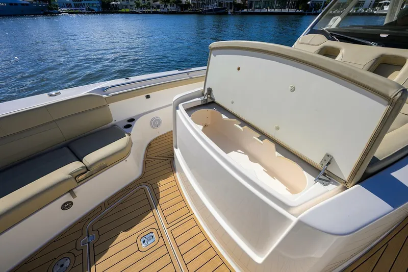 Leap Year Yacht Photos Pics 2018 Pursuit S 408 Sport boat interior with open storage compartment and cushioned seating.