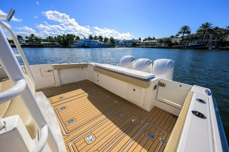 Leap Year Yacht Photos Pics 2018 Pursuit S 408 Sport boat deck with scenic waterfront view.