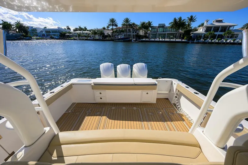 Leap Year Yacht Photos Pics 2018 Pursuit S 408 Sport boat with spacious deck overlooking waterfront homes.