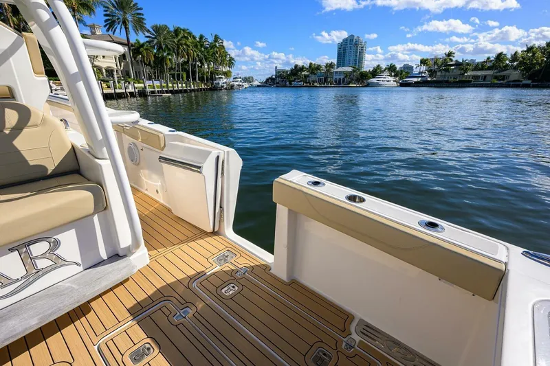 Leap Year Yacht Photos Pics 2018 Pursuit S 408 Sport boat on scenic waterfront with palm trees and clear skies.