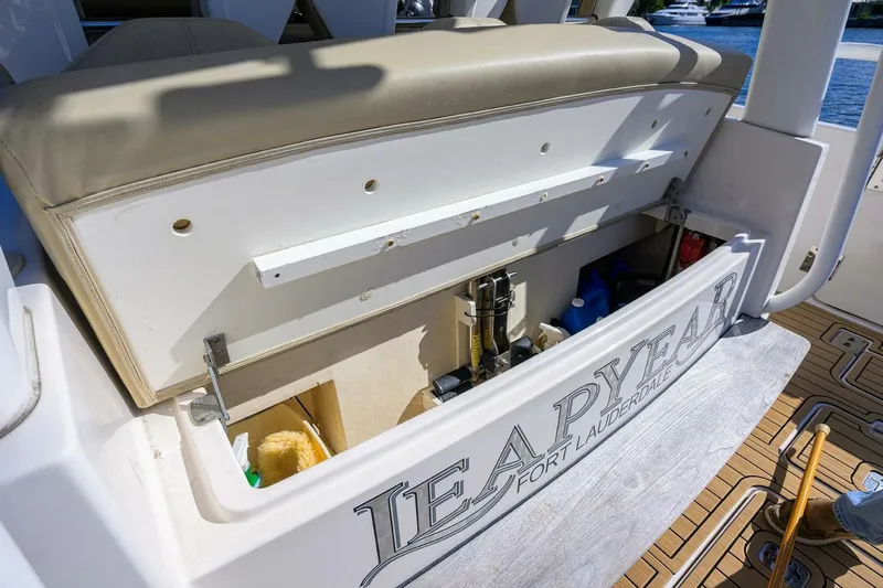 Leap Year Yacht Photos Pics 2018 Pursuit S 408 Sport boat storage compartment, open with visible equipment and supplies.