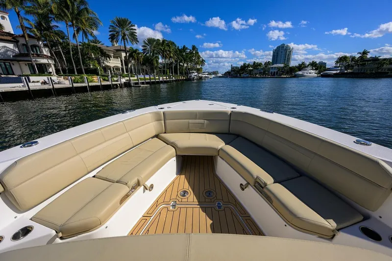 Leap Year Yacht Photos Pics 2018 Pursuit S 408 Sport boat with spacious seating, cruising on a scenic waterway.