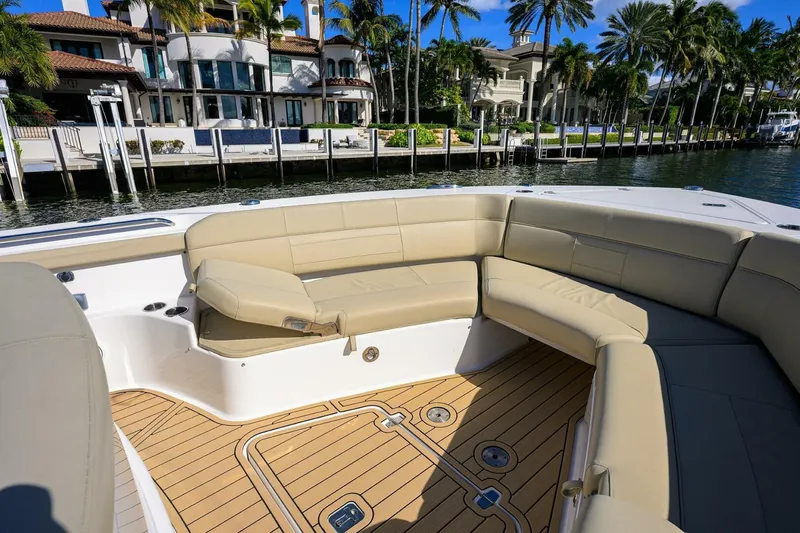 Leap Year Yacht Photos Pics Luxurious 2018 Pursuit S 408 Sport boat interior with beige seating and waterfront view.