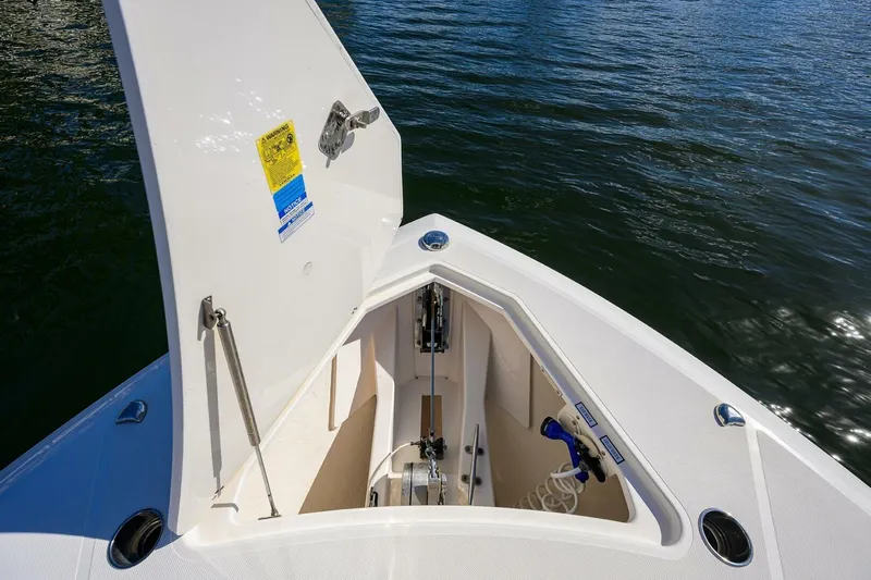 Leap Year Yacht Photos Pics Open storage compartment on 2018 Pursuit S 408 Sport boat, docked on calm water.