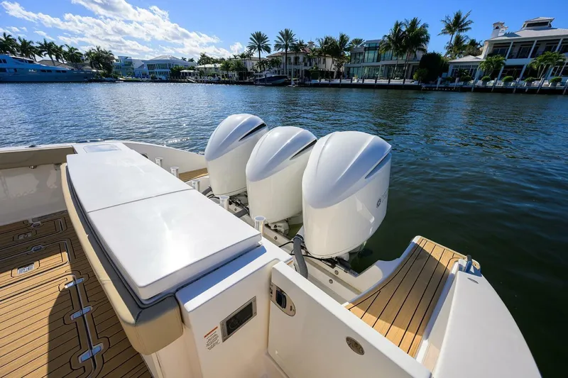 Leap Year Yacht Photos Pics 2018 Pursuit S 408 Sport boat with triple outboard engines on a sunny waterfront.