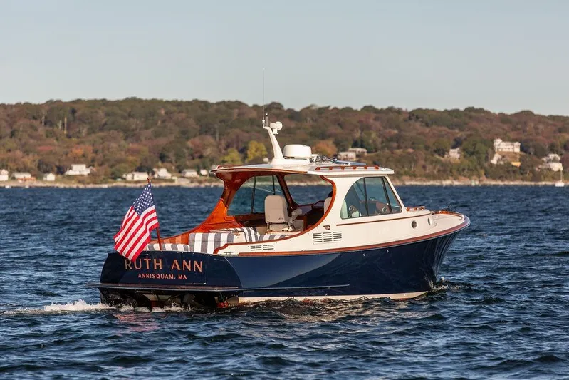 Ruth Ann Yacht Photos Pics 2023 Hinckley Picnic Boat 34 S cruising on water with American flag.