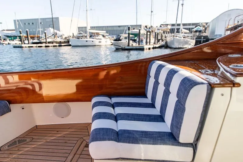 Ruth Ann Yacht Photos Pics 2023 Hinckley Picnic Boat 34 S with striped seating, docked at marina.