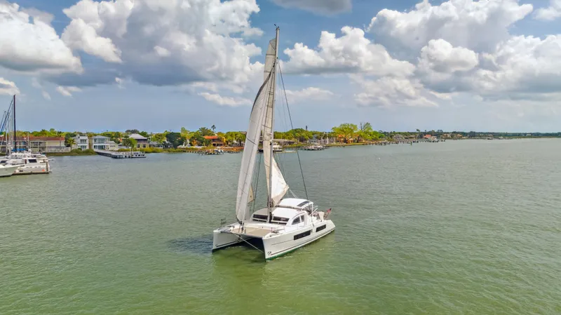 Zephyr Yacht Photos Pics Catana 42 catamaran sailing on a calm sea under a partly cloudy sky, 2016 model.
