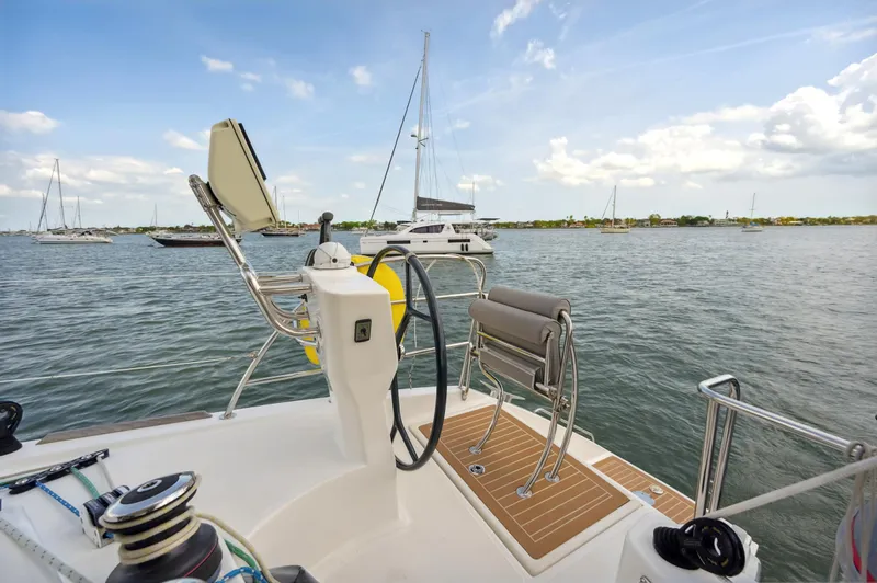 Zephyr Yacht Photos Pics Catana 42 sailboat helm, 2016 model, overlooking serene marina waters.