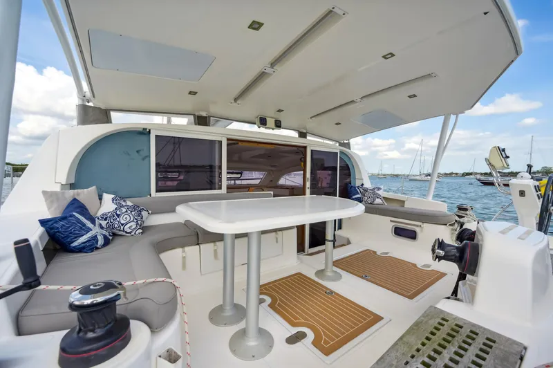 Zephyr Yacht Photos Pics Spacious Catana 42 catamaran cockpit with seating, table, and ocean view, 2016 model.