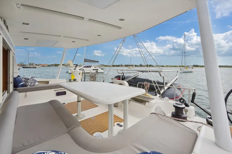 Zephyr Yacht Photos Pics Catana 42 catamaran 2016, spacious deck with seating, docked in a sunny marina.