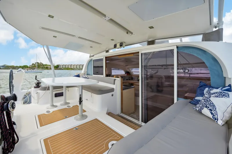 Zephyr Yacht Photos Pics 2016 Catana 42 catamaran interior with seating, table, and sliding doors.