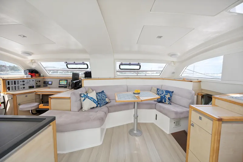 Zephyr Yacht Photos Pics Spacious interior of 2016 Catana 42 catamaran with modern seating and navigation area.