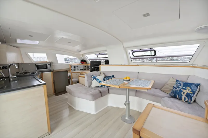 Zephyr Yacht Photos Pics Spacious interior of 2016 Catana 42 catamaran with modern kitchen and cozy seating area.