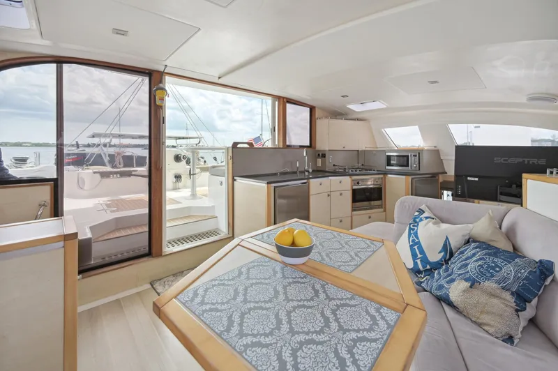 Zephyr Yacht Photos Pics Interior of 2016 Catana 42 yacht with modern kitchen and cozy seating area.