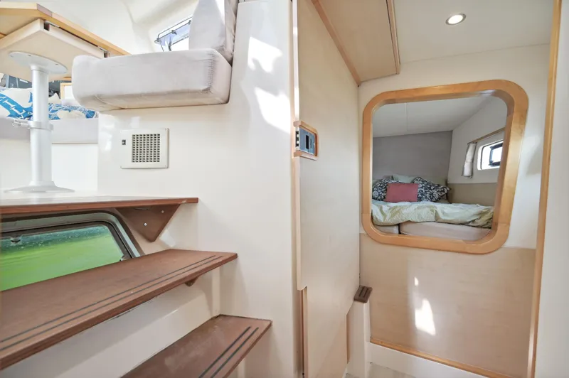Zephyr Yacht Photos Pics Interior of 2016 Catana 42 yacht with cozy cabin and wooden stairs.