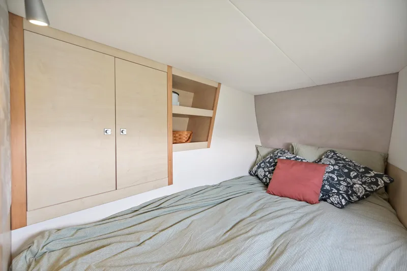 Zephyr Yacht Photos Pics Cozy bedroom in 2016 Catana 42 yacht with storage and decorative pillows.
