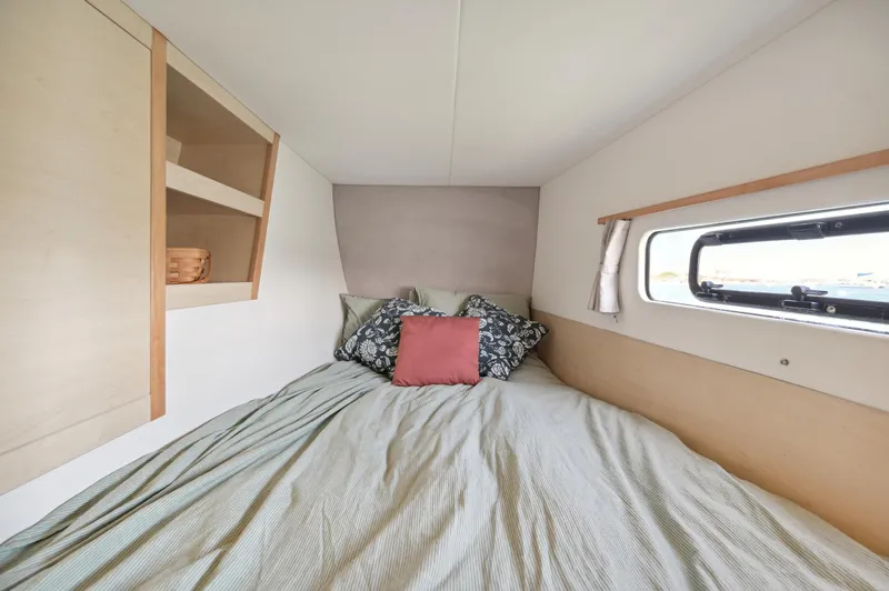 Zephyr Yacht Photos Pics Cozy bedroom in 2016 Catana 42 yacht with window and shelving.