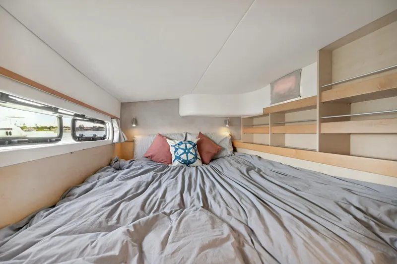 Zephyr Yacht Photos Pics Cozy bedroom interior of 2016 Catana 42 yacht with nautical-themed decor.