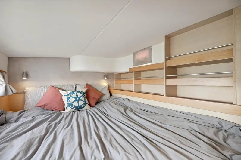 Zephyr Yacht Photos Pics Cozy bedroom in 2016 Catana 42 yacht with modern decor and nautical-themed pillows.