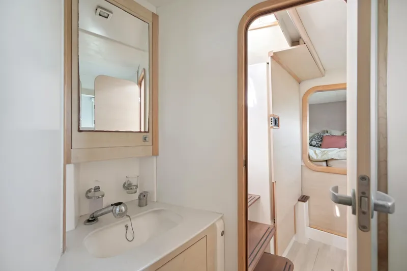 Zephyr Yacht Photos Pics Interior of 2016 Catana 42 catamaran featuring bathroom and cozy cabin.