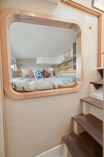 Zephyr Yacht Photos Pics Interior of 2016 Catana 42 yacht with cozy bedroom and wooden stairs.