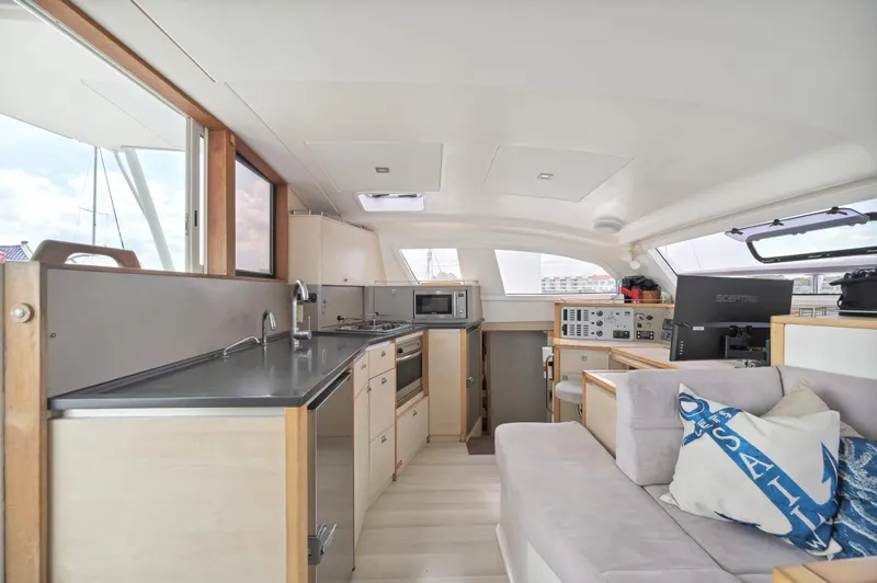 Zephyr Yacht Photos Pics Modern interior of 2016 Catana 42 catamaran with kitchen and seating area.