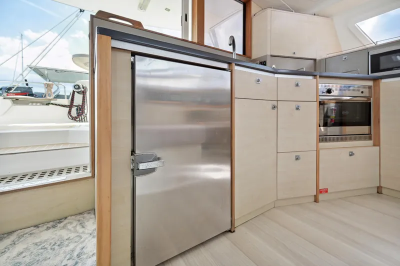 Zephyr Yacht Photos Pics Modern kitchen interior of 2016 Catana 42 yacht with stainless steel appliances.