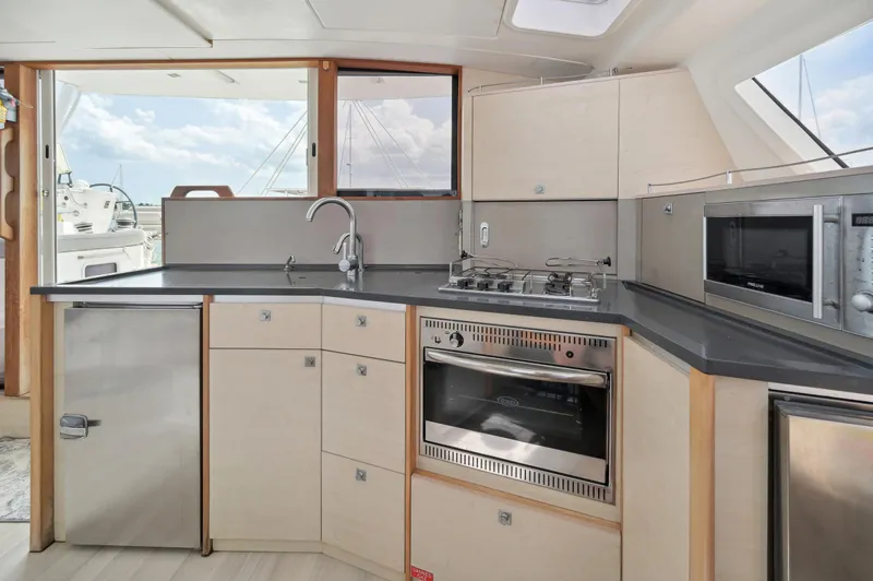 Zephyr Yacht Photos Pics Modern kitchen interior of 2016 Catana 42 yacht with stainless steel appliances.