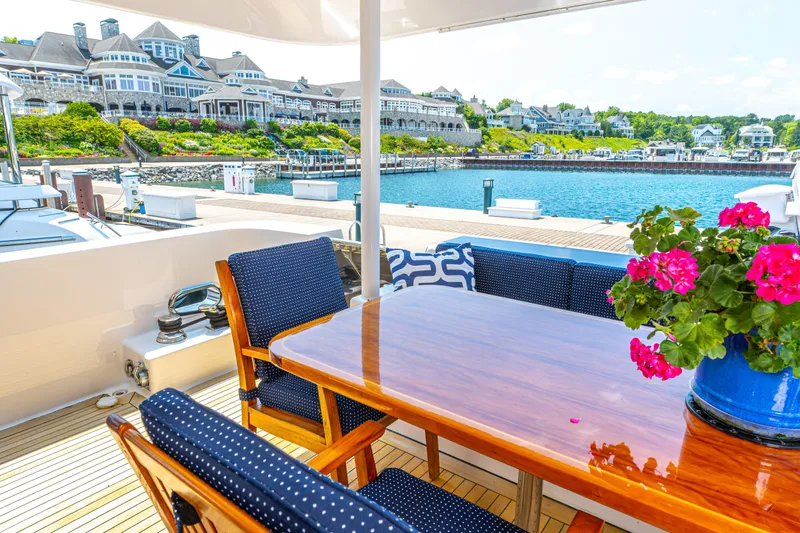  Yacht Photos Pics Outdoor dining area on a 2005 Pacific Mariner 85 Motor Yacht with waterfront view.