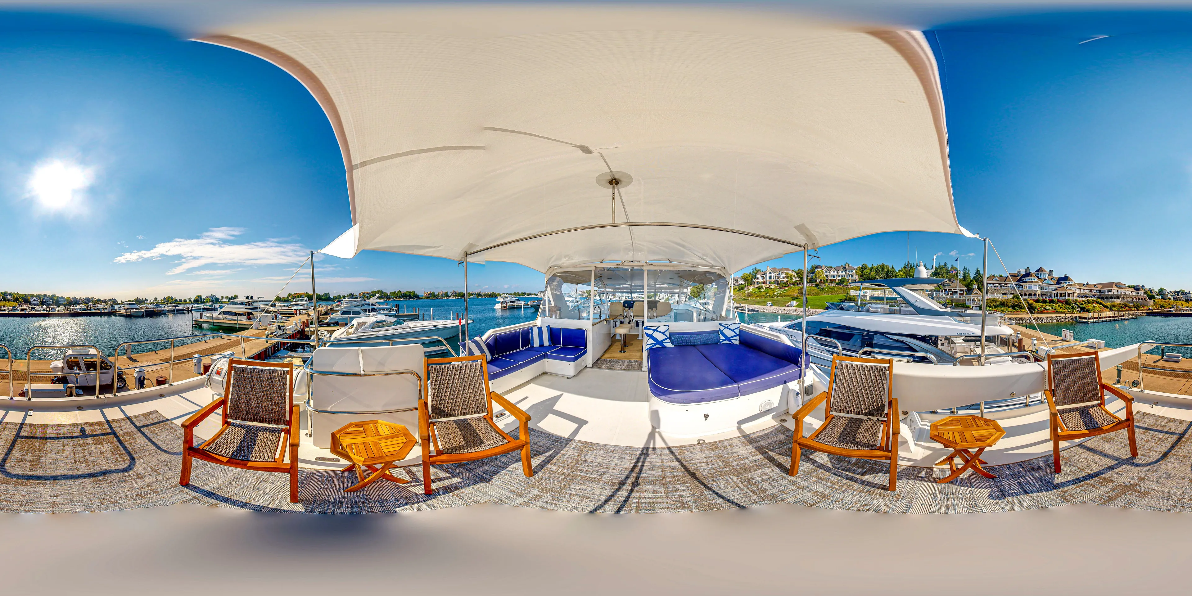  Yacht Photos Pics 2005 Pacific Mariner 85 Motor Yacht deck with seating and canopy, docked at marina.