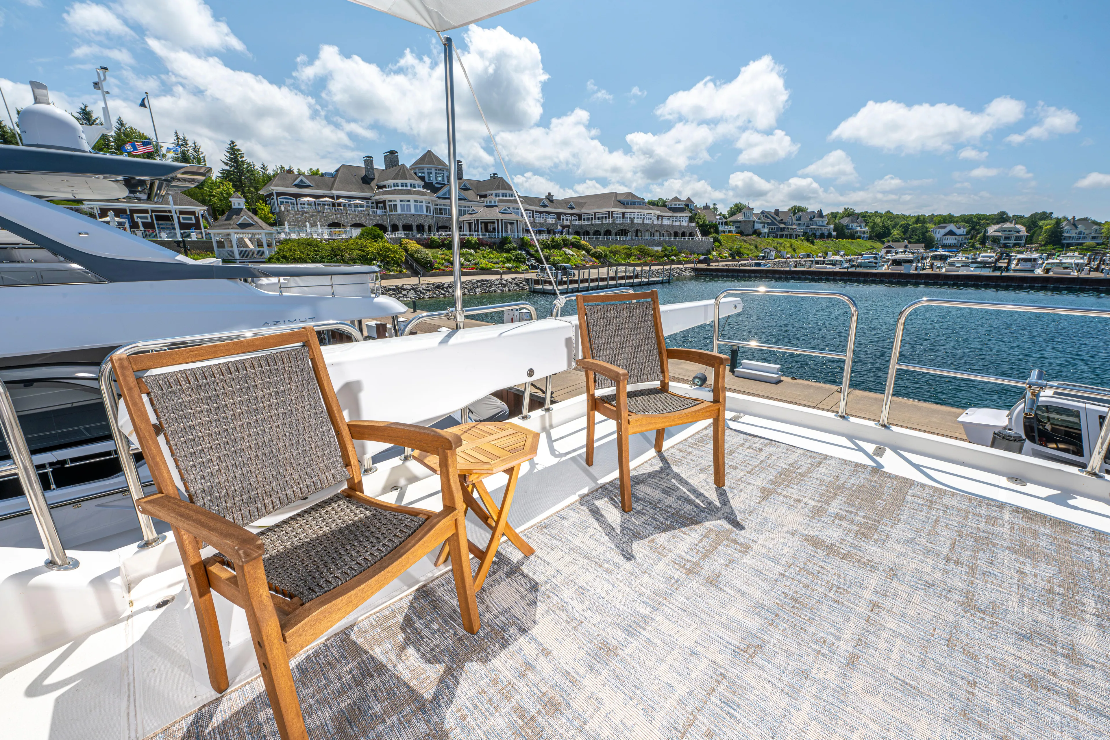  Yacht Photos Pics 2005 Pacific Mariner 85 Motor Yacht deck with chairs overlooking marina.